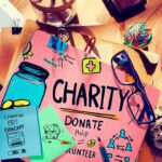 Donate to charity banner and spectacles lying on the table