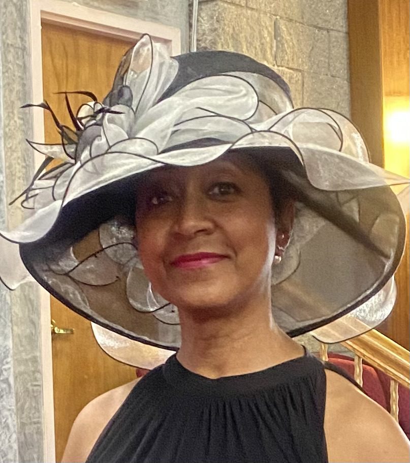 Woman wearing large elegant black and white hat